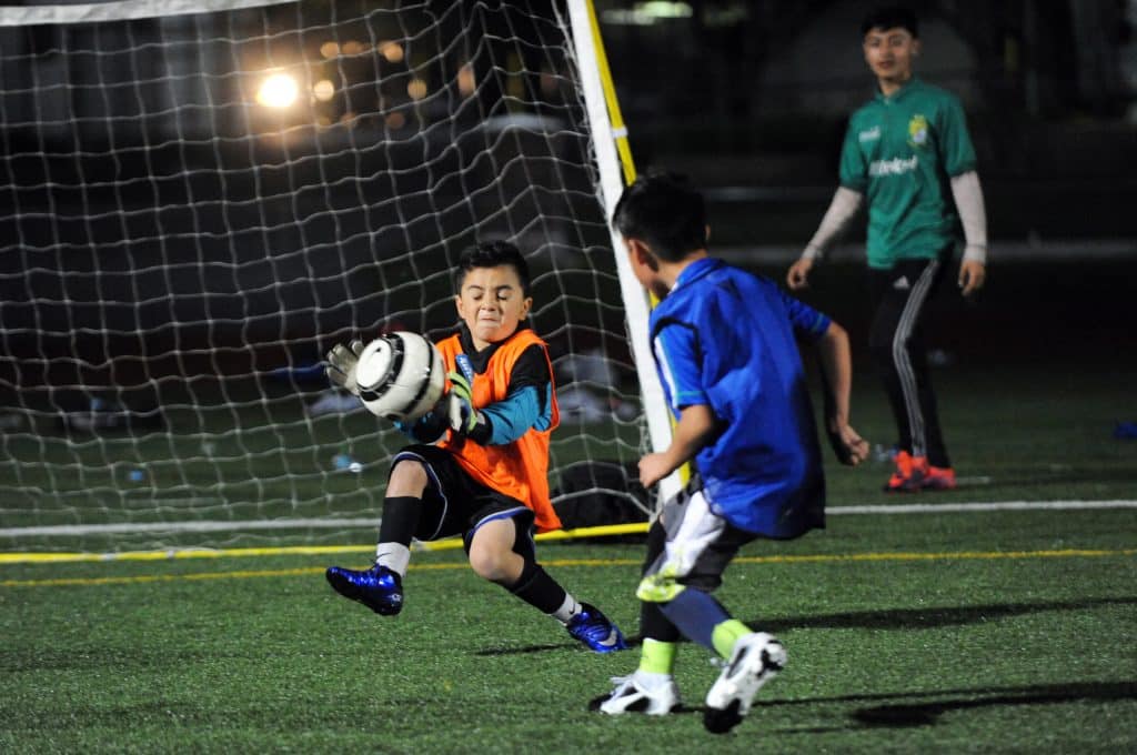 A young goalkeeper makes a save during CCFAs World Cup, where free clinic participants square off representing their favorite teams.
Salinas Youth Initiative: César Chávez Fútbol Academy
United States, California, Monterey County, Salinas, Monterey, Jay Dunn, The Packard Foundation, César Chávez Fútbol Academy, photographer, freelance, photography, multimedia, video, social justice, social services, photojournalism, www.jaydunn.org, jay@jaydunn.com