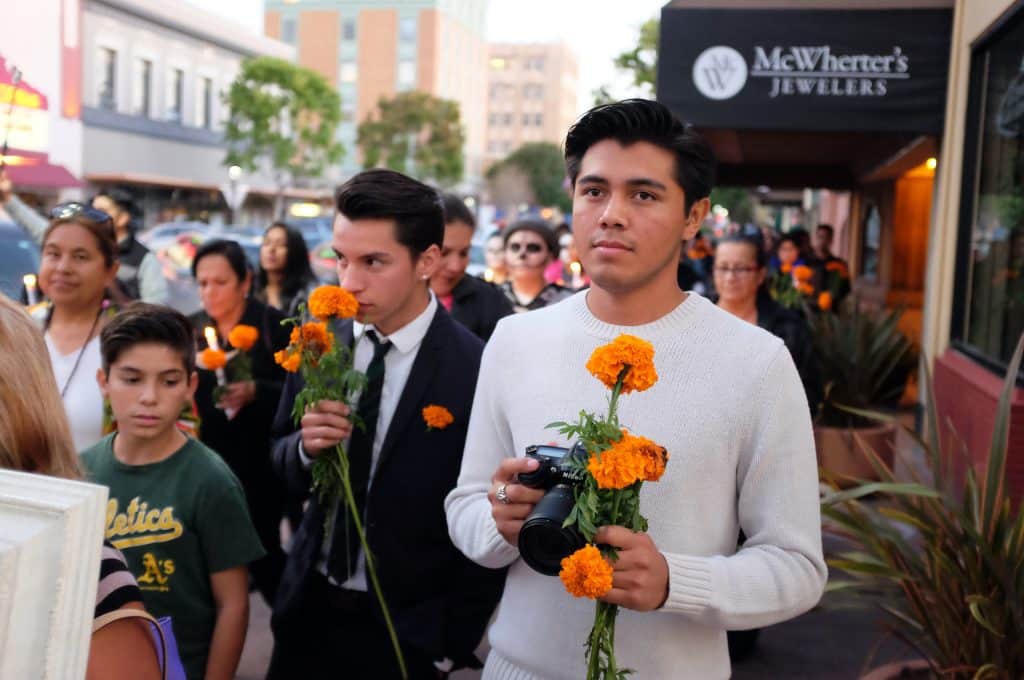 Josué Rubio, center, and David Aguilar of Hijos del Sol walk along Main Street in Salinas in the evening Procession of Catrinas, part of the group’s 2016 Day of the Dead commemoration. (c)Jay_Dunn_1_773_817_0547